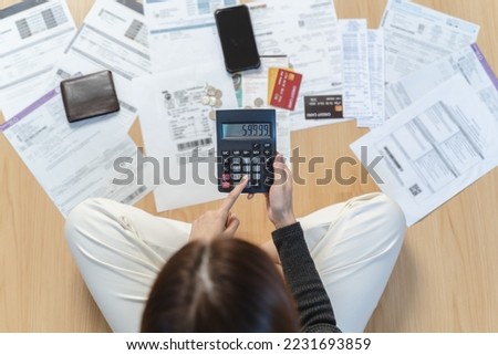 Sad Asian woman looking at many credit cards in her hand and worried about loan debt pay late. Foto d'archivio © 
