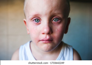 Sad baby crying. Sad child. Tears stream down the little boy's face.