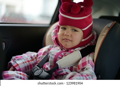 Sad Baby Girl In Car Seat In Winter Time