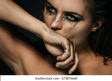 Sad And Beautiful Woman With Smudged Makeup On Her Face