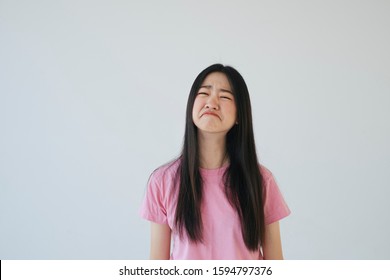 Sad black long hair girl in pink t-shirt turn her mouth upside down and cry.