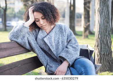 Sad Black Woman Seated Alone On A Bench At The Park