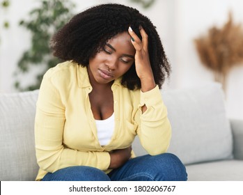 Sad Black Woman Suffering From PMS And Menstruation Pain. Having Stomach Ache, Abdominal Pain And Headache