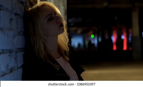 Sad Blonde Woman Standing Alone Outside Nightclub, Melancholy, Loneliness