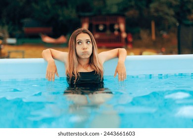 
Sad Bored Lady Sitting in the Pool at Home. Unhappy girl spending summer vacation by herself suffering from boredom 
 - Powered by Shutterstock