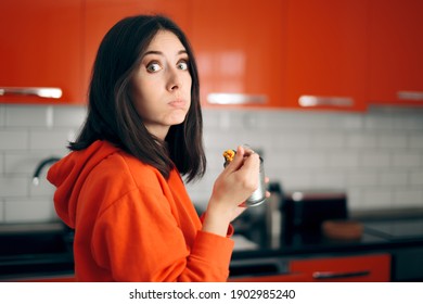 Sad Bored Woman Eating From A Can In The Kitchen. Young Person Unable To Cook Eating Canned Food 
