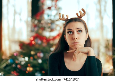 Sad Bored Woman Having No Fun At Christmas Dinner Party - Funny Girl Wearing Reindeer Horns Headband At Xmas Party
