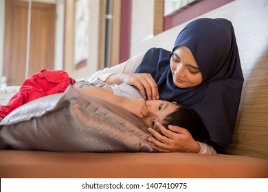 Sad Boy Being Comforted By His Muslim Mother At Home