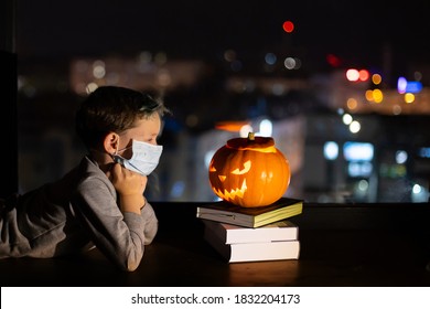 Sad Boy Celebrating Halloween Alone Social Distance. A Child In A Mask On The Eve Of All Saints Day. Kid In A Protective Medical Mask. Covid-19 Coronavirus Pandemic 2020. Treat Or Trick  No Party