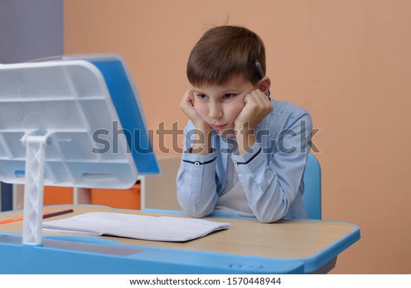 kid doing homework sad