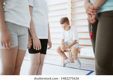 Sad Boy Excluded From The Group During Physical Education