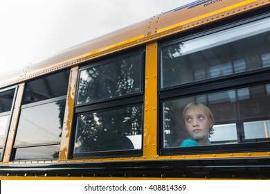 Sad Boy Looking Out School Bus Window