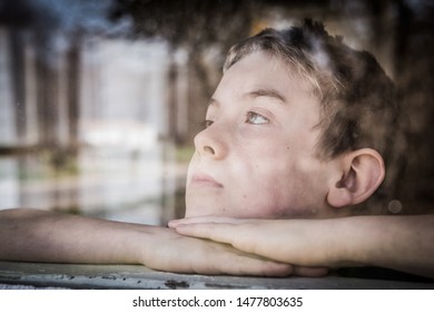 Sad Boy Looking Out A Window