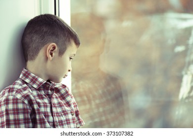 Sad Boy Sitting Near Window