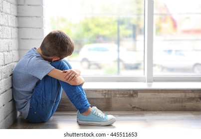 Sad Boy Sitting Near Window