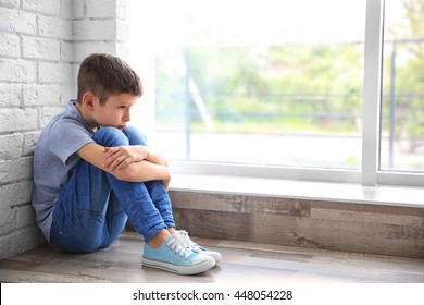 Sad Boy Sitting Near Window