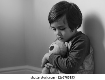 Sad Boy Wearing Pyjamas Cuddle Teddy Bear Sitting At Corner In The Morning, Lonely Kid Looking Dow With Sad Face, Scared Child Waking Up Because Of Bad Dream,Toddler Hugging Teddy ,Mental Health Child