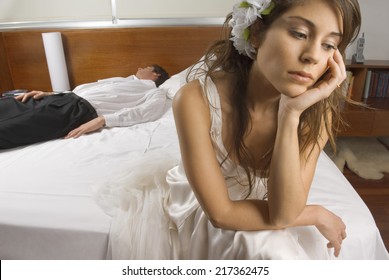 Sad Bride With Groom Asleep In Background