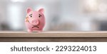 sad and broken pink piggy bank with a blessed one - concept of failure in saving and bad finances