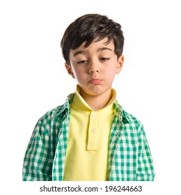 Sad Brunette Kid Over Isolated White Background 