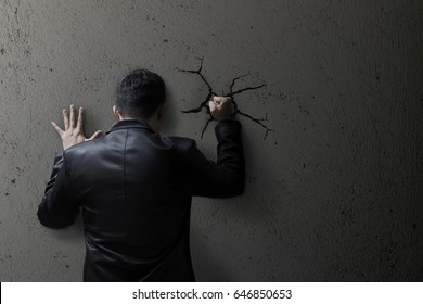 Sad business man feeling bad, hopeless, depressed, frustrated and repressed, Man hit the wall. Wall crack.