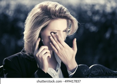 Sad Business Woman Calling On Cell Phone On City Street