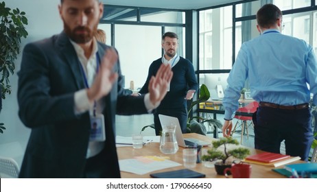 Sad Caucasian Businessman Failed At Public Presentation Conference. Displeased Business People Coworkers Leaving Meeting Room. Bad Day.