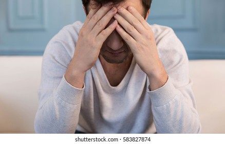 Sad Cheerless Man Covering His Face