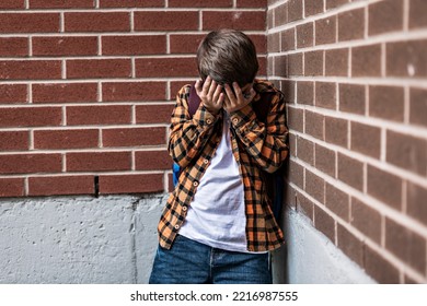 A Sad Child Boy Posing On The School Playground