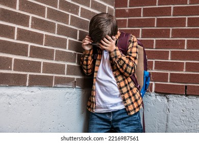 A Sad Child Boy Posing On The School Playground