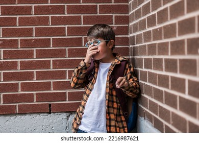 A Sad Child Boy Posing On The School Playground