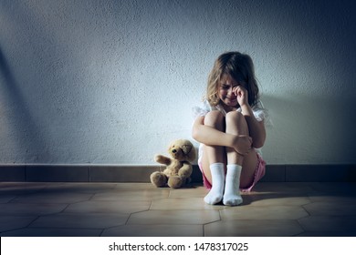 Sad Child Girl Crying On The Floor
