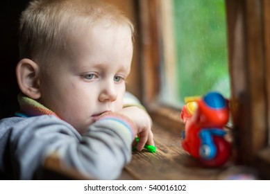 A Sad Child - A Little Boy At The Window