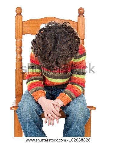 Sad child sitting on a chair isolated on a over white background