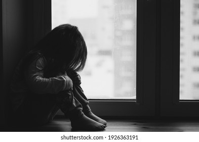sad child at the window, black and white - Shutterstock ID 1926363191