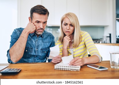 Sad Couple Calculating Home Finances