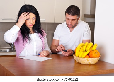 Sad Couple Having Difficult To Calculate Their Expenses