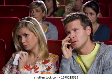 Sad couple in movie theater - Powered by Shutterstock