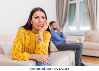 Sad Couple Not Talking To Each Other After Quarrel. Pensive Upset Woman Feeling Offended, Thinking Over Problems In Relationships, Anxious About Future, Upset Man Sitting In The Background