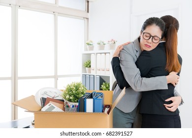 Sad Crying Business Manager Is Layoff From Company Feeling Depression And Pretty Elegant Office Worker Girl Giving Her Hug To Console.