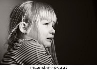 Sad crying child. Black and white.