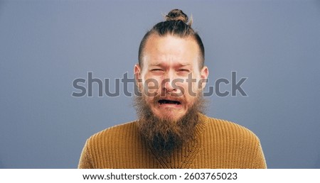 Sad, crying and man with depression in studio for mental health, grief and loss with mockup space. Emotional, portrait and person on gray background for mourning, broken heart or trauma from bad news
