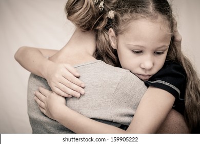 Sad Daughter Hugging His Mother