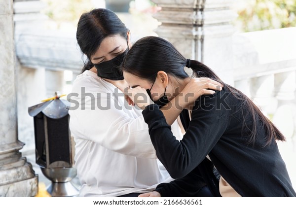 Sad daughter with understanding mother in\
religious service