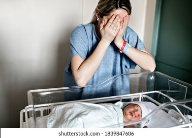 Sad And Depress Mother With Her Newborn Baby At The Hospital A Day After A Natural Birth Labor