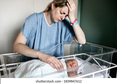 Sad And Depress Mother With Her Newborn Baby At The Hospital A Day After A Natural Birth Labor