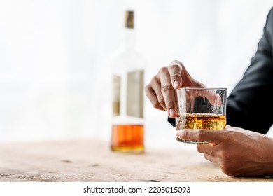 Sad depressed addicted drunk guy, Alone asian man drinker alcoholic sitting at bar counter with glass drinking whiskey. - Shutterstock ID 2205015093