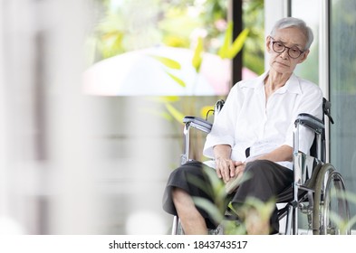 Sad and depressed asian senior woman sitting alone in wheelchair with head down feel lonely and bored,disabled old elderly with loneliness waiting for her family to come visit her at the nursing home - Powered by Shutterstock