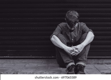 Sad And Depressed Man Sitting Alone