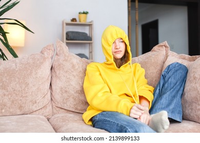 Sad, Depressed Teenage Girl Is Sitting Alone On The Couch At Home. Millennial Teen Girl Ignores Everyone